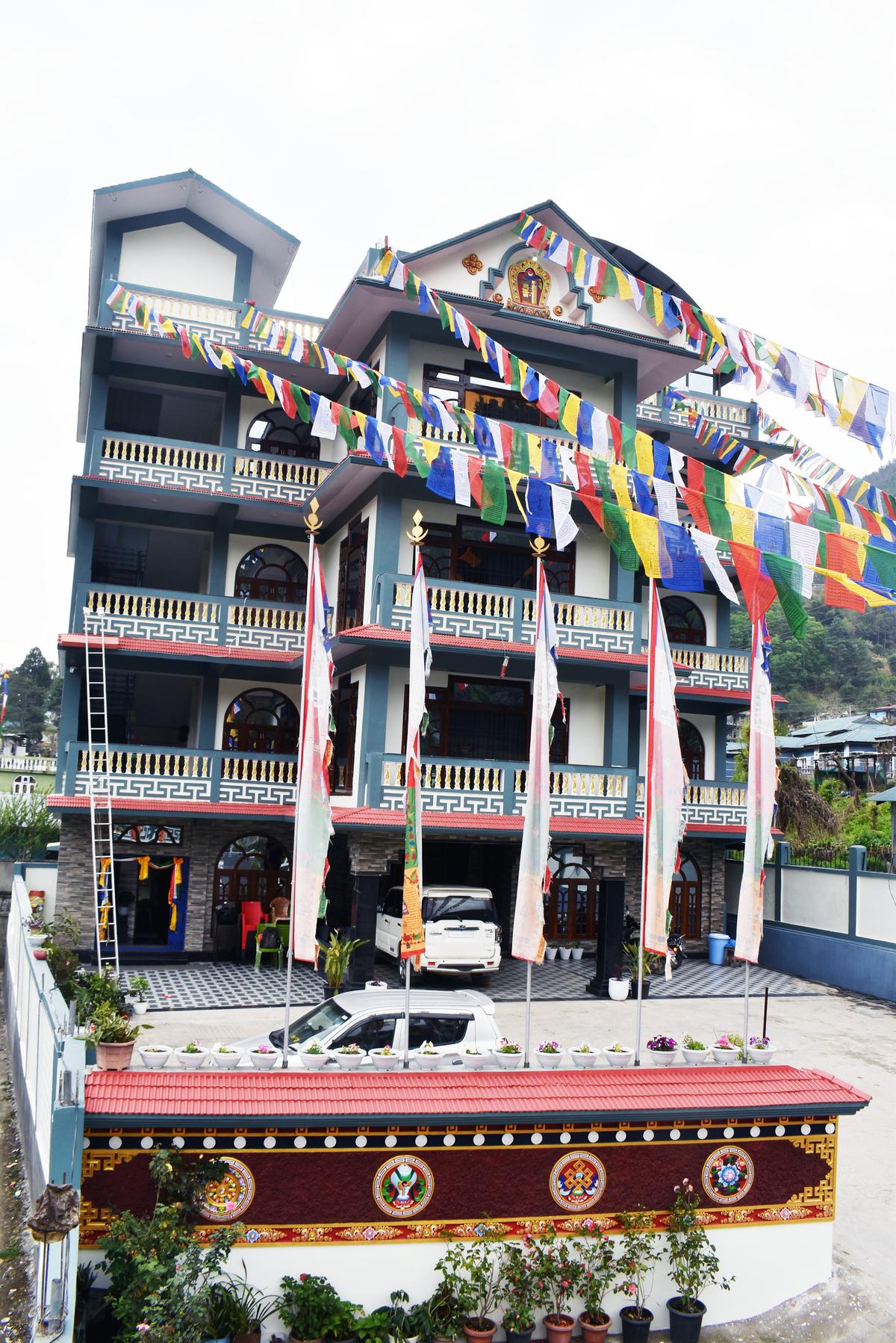 Hotel Pema Lhatse - Traditional Monpa architecture hotel in Dirang, Arunachal Pradesh with prayer flags and mountain backdrop