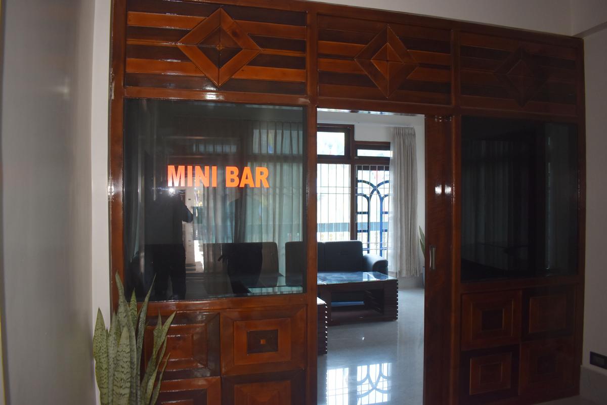 Mini bar entrance with wooden door frame and MINI BAR signage at Hotel Pema Lhatse