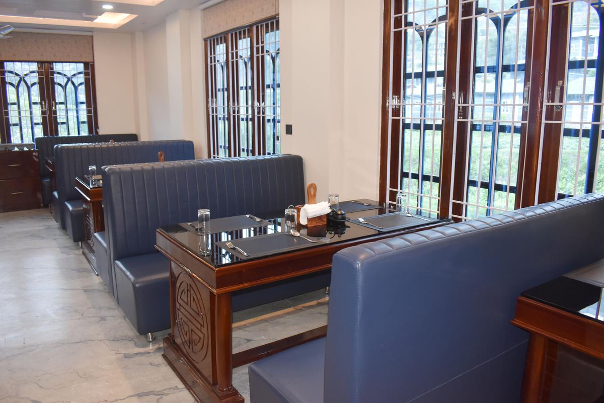 Spacious dining area at Hotel Pema Lhatse with premium blue leather booth seating and natural light